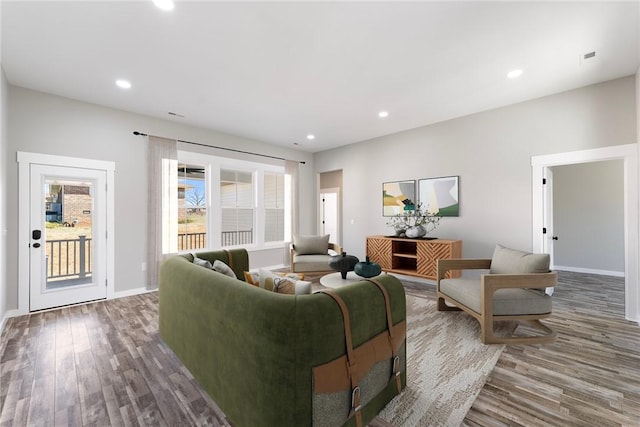 living room featuring recessed lighting, baseboards, and wood finished floors