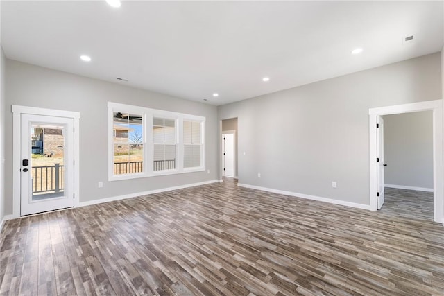 interior space featuring baseboards, wood finished floors, and recessed lighting