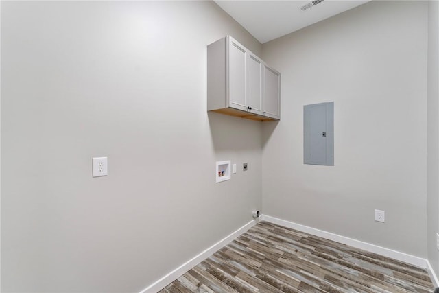 laundry room with electric panel, cabinet space, electric dryer hookup, and baseboards