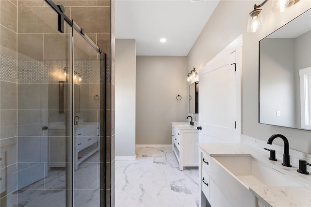 bathroom featuring marble finish floor, two vanities, a sink, and a shower stall