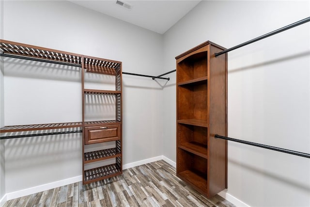 walk in closet featuring visible vents and wood finished floors