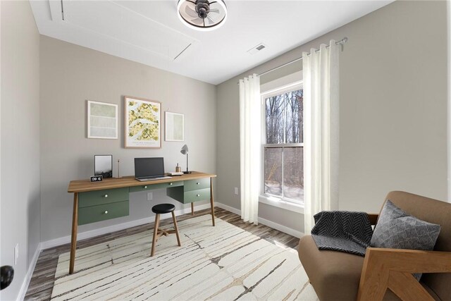 office area with attic access, visible vents, plenty of natural light, and wood finished floors