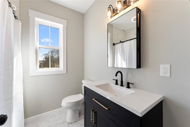 bathroom with toilet, marble finish floor, vanity, and baseboards