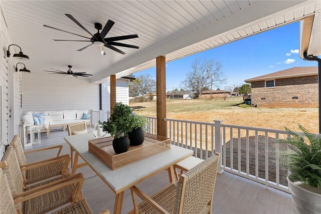 view of patio featuring a ceiling fan and an outdoor living space