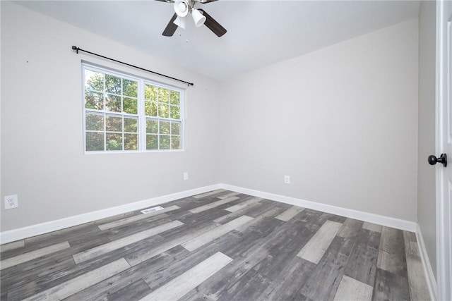 empty room featuring ceiling fan and dark hardwood / wood-style flooring