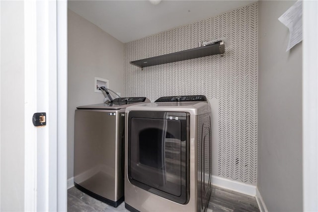 clothes washing area featuring washing machine and clothes dryer and hardwood / wood-style flooring