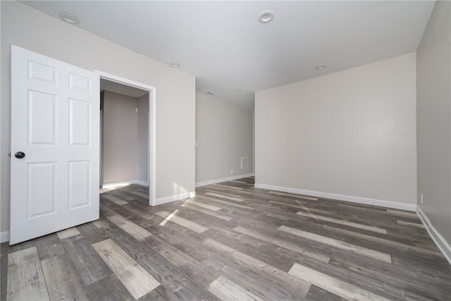 spare room featuring dark wood-type flooring