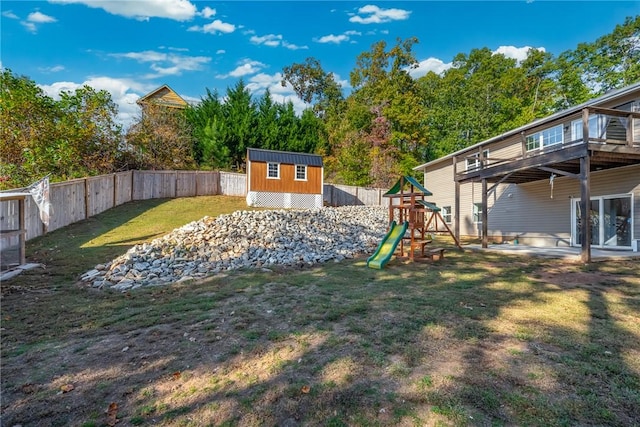 view of yard featuring a storage shed and a playground