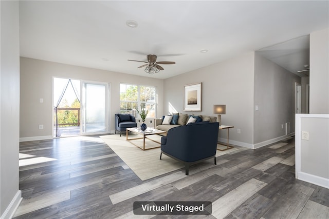 living room featuring ceiling fan and dark hardwood / wood-style floors