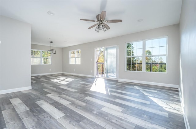 unfurnished living room with ceiling fan and wood-type flooring