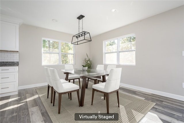 dining space with dark wood-type flooring