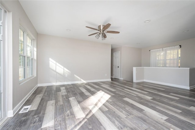 unfurnished room featuring ceiling fan and hardwood / wood-style floors