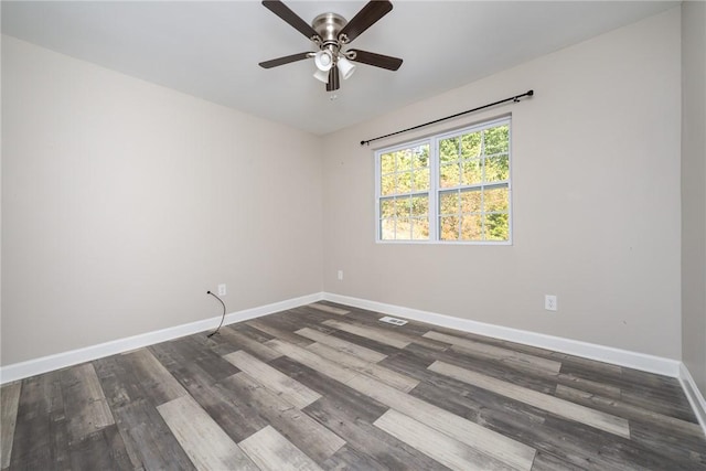 spare room with ceiling fan and dark hardwood / wood-style floors