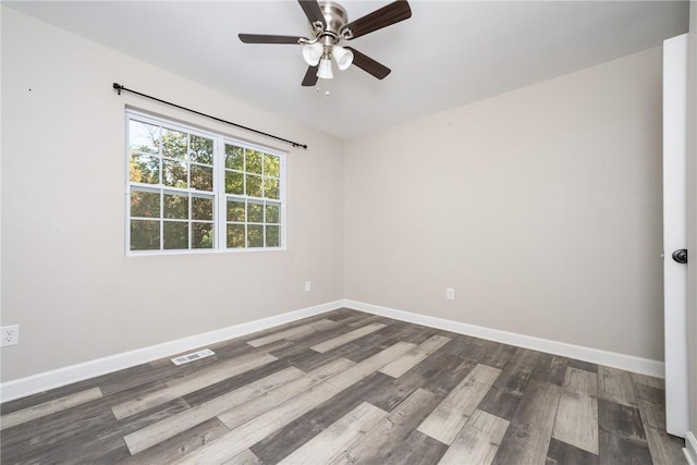 spare room featuring dark wood-type flooring and ceiling fan