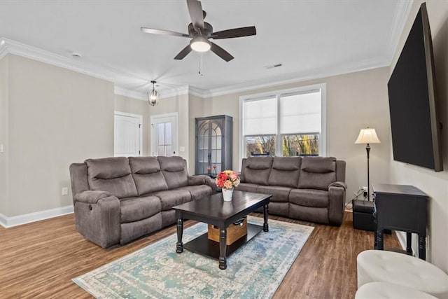 living room with ceiling fan, ornamental molding, and hardwood / wood-style floors