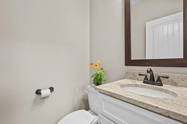 bathroom with toilet and vanity