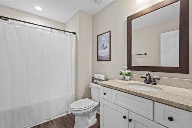 full bathroom with toilet, vanity, shower / bath combination with curtain, and hardwood / wood-style floors