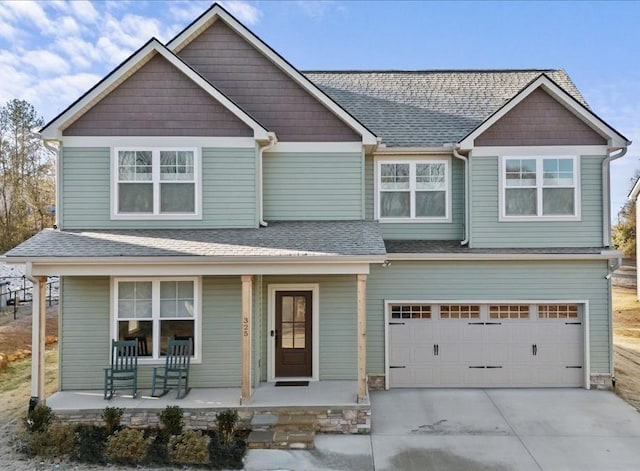 view of front of property featuring a porch and a garage