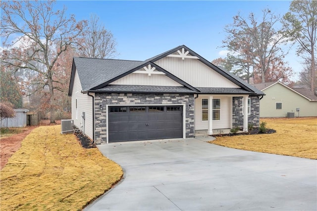 craftsman-style house featuring cooling unit and a garage