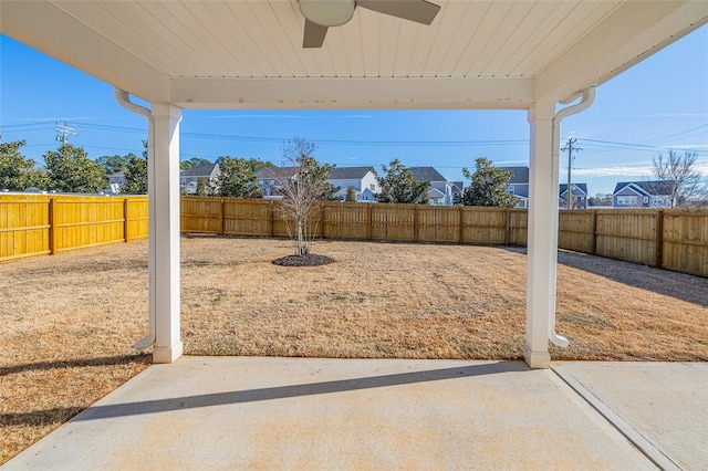 view of yard with ceiling fan and a patio