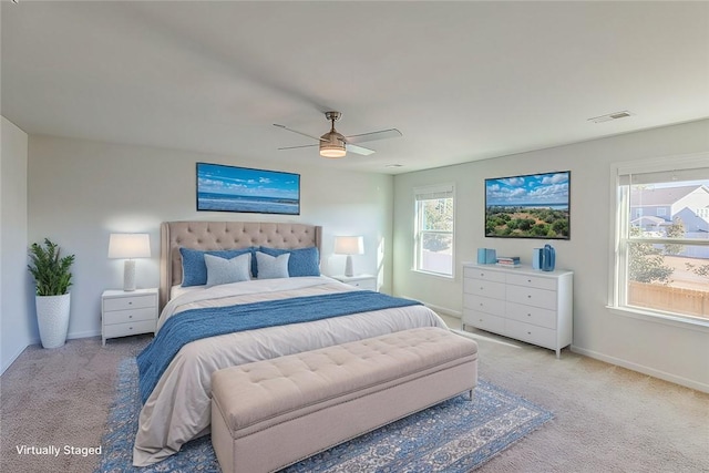 carpeted bedroom featuring ceiling fan and multiple windows