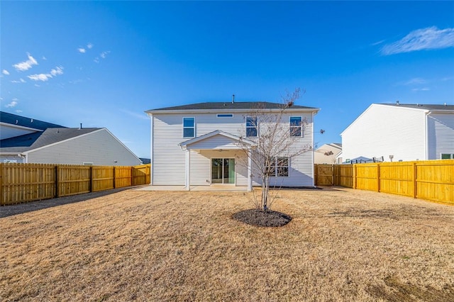 rear view of property featuring a yard