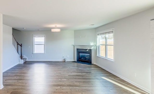 unfurnished living room with hardwood / wood-style flooring and plenty of natural light