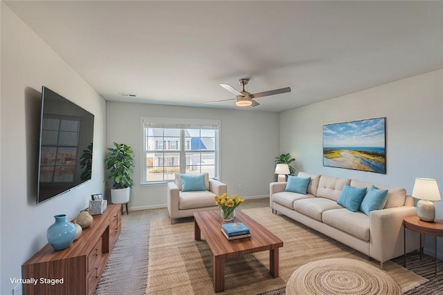 living room featuring ceiling fan and light colored carpet