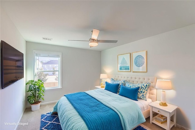 bedroom with ceiling fan and light colored carpet