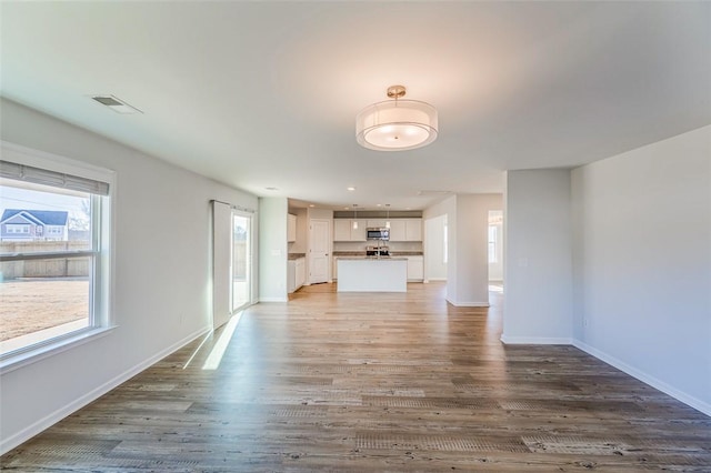 unfurnished living room with wood-type flooring