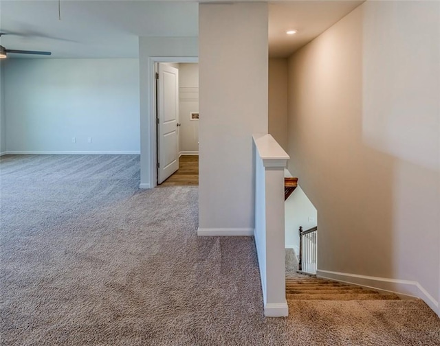 interior space featuring carpet floors and ceiling fan