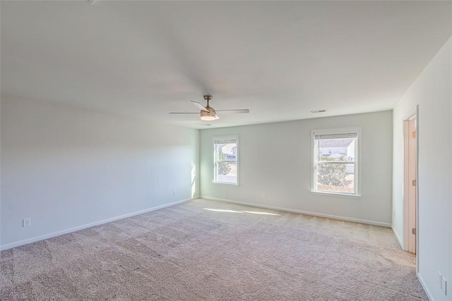 carpeted empty room featuring ceiling fan