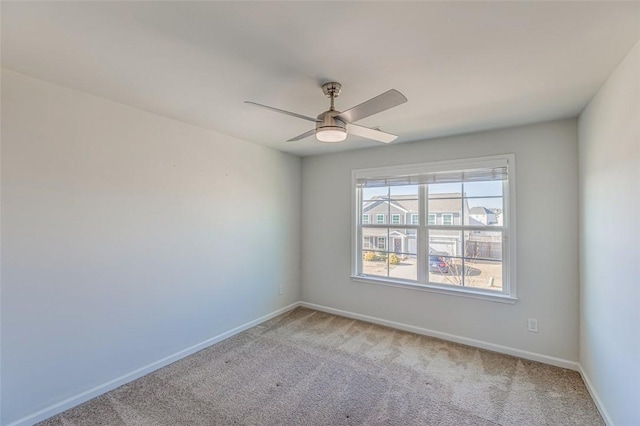 spare room featuring ceiling fan and light colored carpet