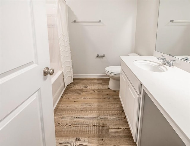 full bathroom with toilet, vanity, wood-type flooring, and shower / bath combo with shower curtain