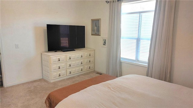 bedroom featuring light colored carpet