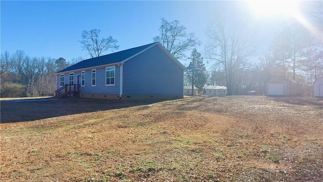 view of side of home featuring a shed and a yard