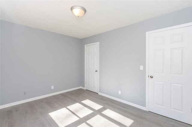 empty room with light hardwood / wood-style floors