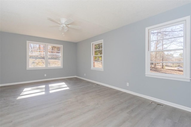 unfurnished room with ceiling fan, a textured ceiling, and light hardwood / wood-style flooring