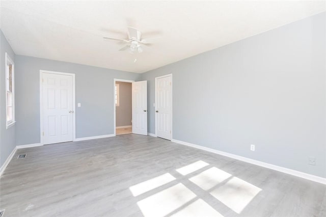 unfurnished bedroom with ceiling fan and light hardwood / wood-style flooring