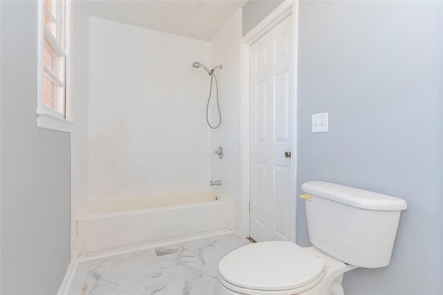 bathroom featuring toilet and bathing tub / shower combination