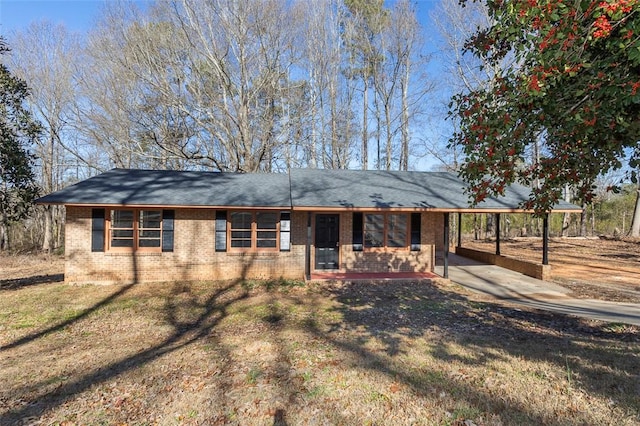 ranch-style home featuring a front yard and a carport