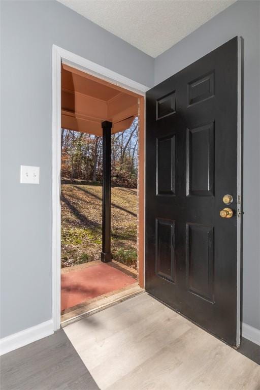 entrance foyer featuring a textured ceiling and hardwood / wood-style floors