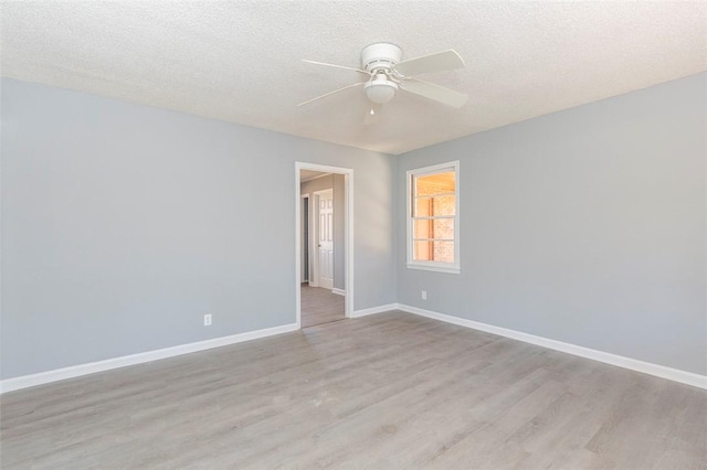 spare room with ceiling fan, a textured ceiling, and light hardwood / wood-style flooring