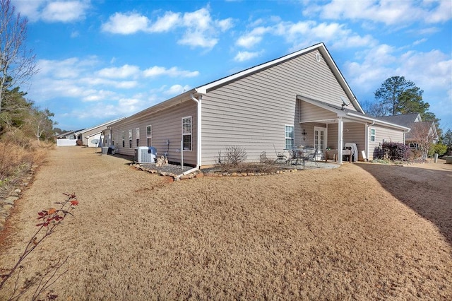 view of property exterior with central AC and a patio