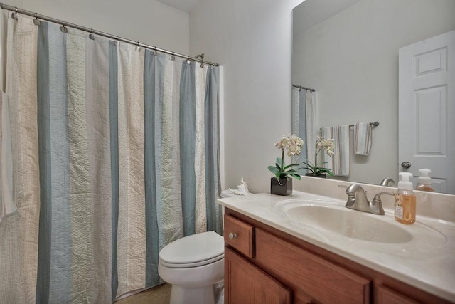 bathroom with toilet, tile patterned floors, and vanity