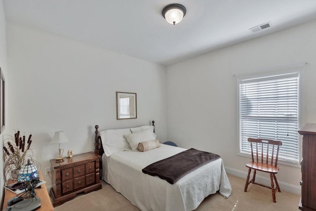 bedroom with light carpet and multiple windows