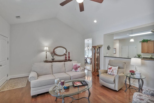 living room featuring ceiling fan, light hardwood / wood-style flooring, and vaulted ceiling