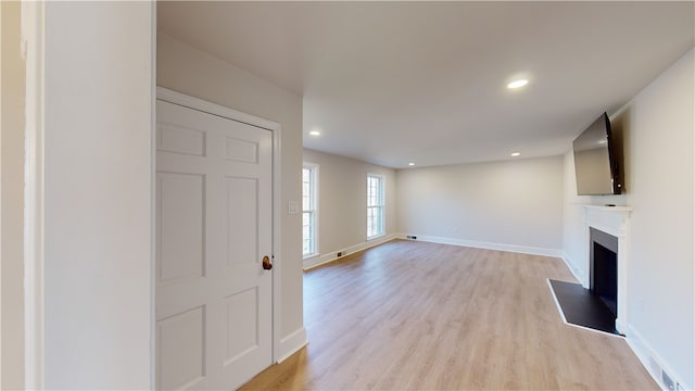 unfurnished living room featuring light hardwood / wood-style floors