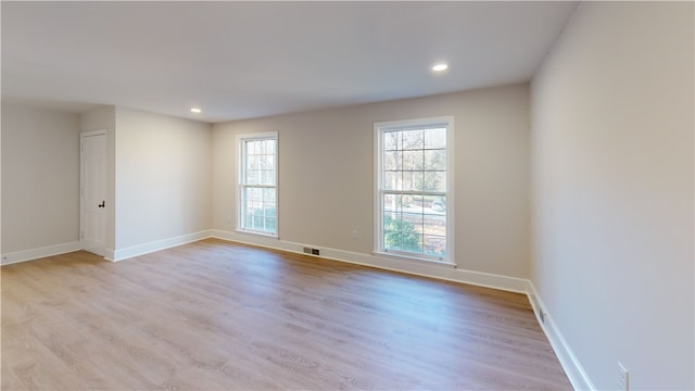 spare room featuring light hardwood / wood-style floors