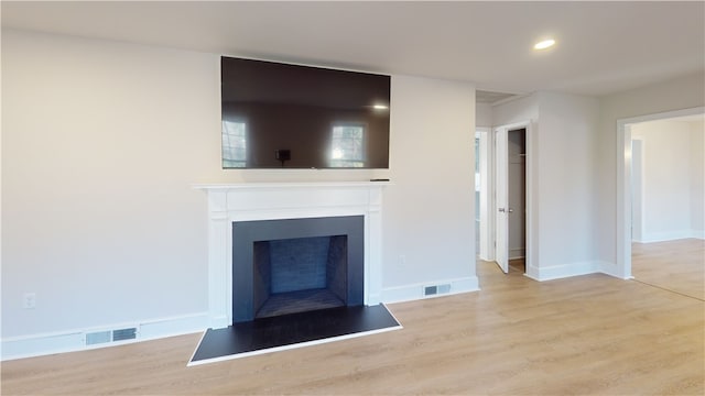 unfurnished living room with light wood-type flooring